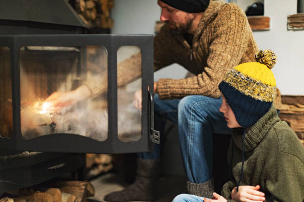 istock Father and son lighting fire to warm up 1429941051