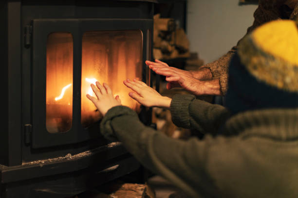 istock Father and son warming hands by a fireplace 1429941080
