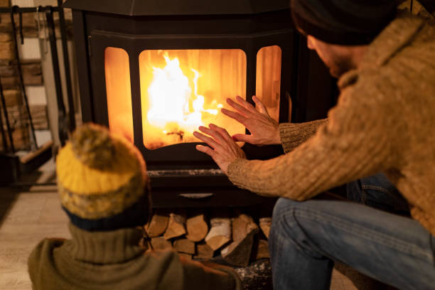 istock Father and son warming hands by a fireplace 1429941107