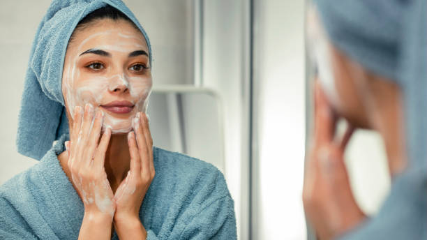 Reflection in a mirror beautiful woman washing her face Reflection in a mirror beautiful woman washing her face skin care stock pictures, royalty-free photos & images
