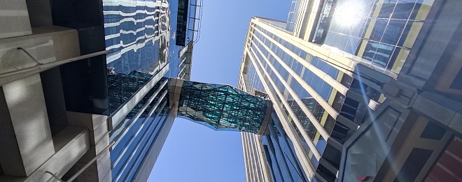 Low angle view of old and new tall buildings.