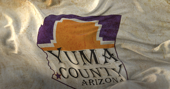 Old flag of Yuma county at sunset, state of Arizona, in United States