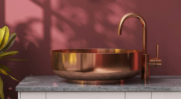 Modern and luxury marble bathroom vanity counter top with brass round washbasin in sunlight and leaf shadow from window on red maroon wall background Modern and luxury marble bathroom vanity counter top with brass round washbasin in sunlight and leaf shadow from window on red maroon wall background for personal care and toiletries product display maroon bathroom stock pictures, royalty-free photos & images