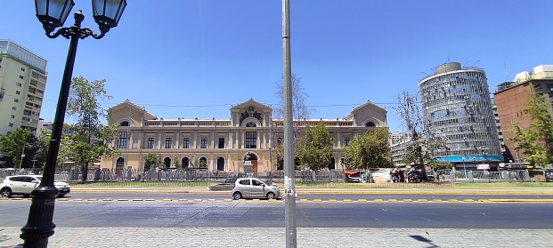 Image of the facade of the University of Chile in a big avenue of the city center of Santiago de Chile