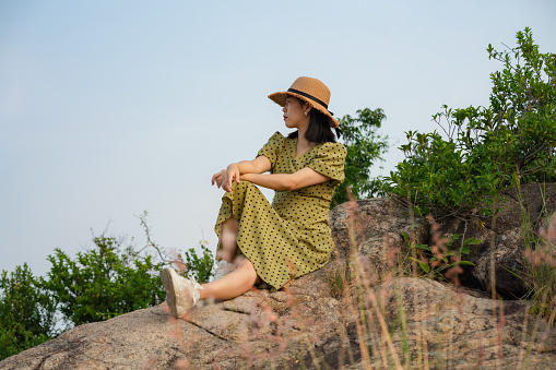 woman sitting on stone admiring the scenery