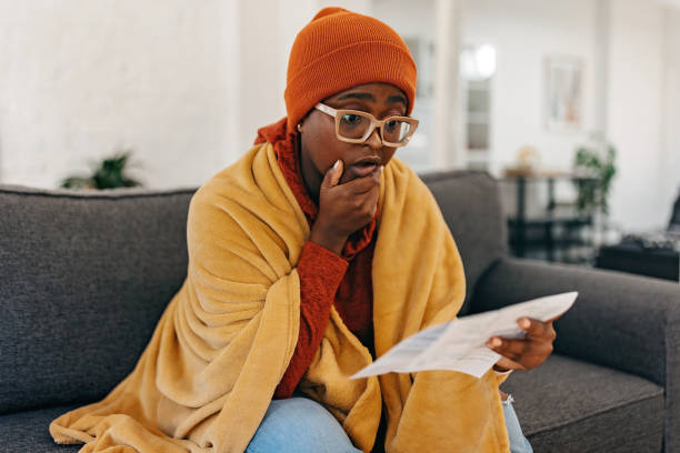 istock Worried woman checking bills at home 1429951079
