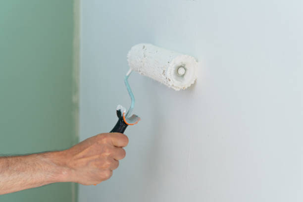 istock Close-up of hand painting the wall with a roller. Copy space. 1429951202