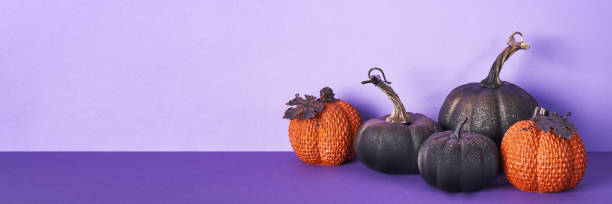 istock Halloween composition with pumpkins on violet banner. Greeting card template, Halloween decorations 1429951640