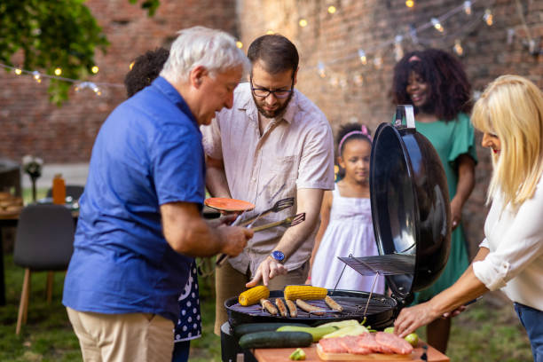 istock Senior man and his son grilling food in a back yard 1429951706