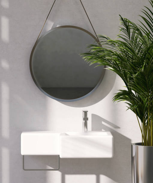 istock Modern and luxury marble bathroom vanity counter top with geometric design washbasin in sunlight and leaf shadow from window on concrete wall background 1429951786