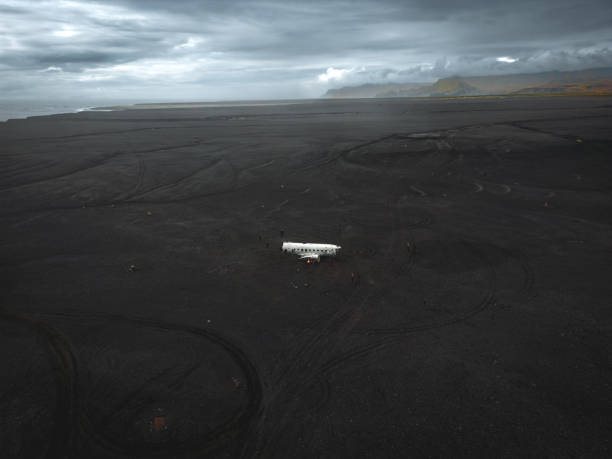 istock Aerial view of a wrecked plane on large empty beach 1429952444