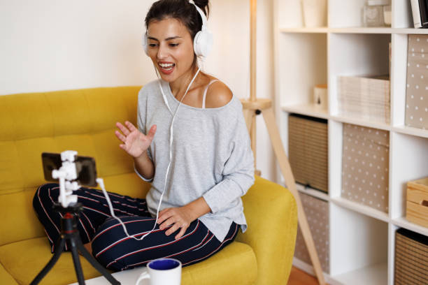 istock Young female life coach making video live broadcast on smartphone at home 1429952526