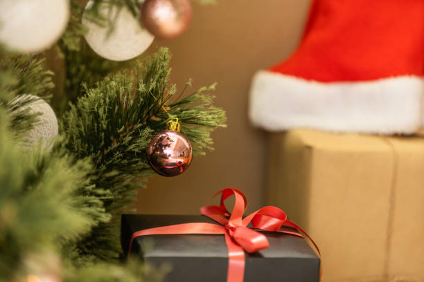 istock Beautiful Christmas gift boxes on floor near fir tree in room. 1429953425