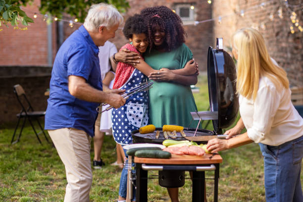 istock Family around the grill at a back yard barbecue party 1429953641