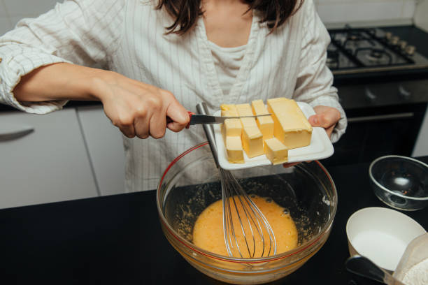 istock Young woman mix ingredients for making cake in kitchen. 1429955178