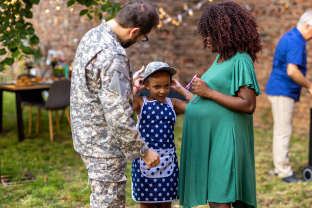 istock Soldier putting his military hat on his daughters head 1429956048