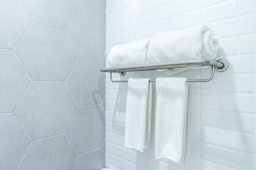 clean white towels with hanger on wall bathroom interior background.
