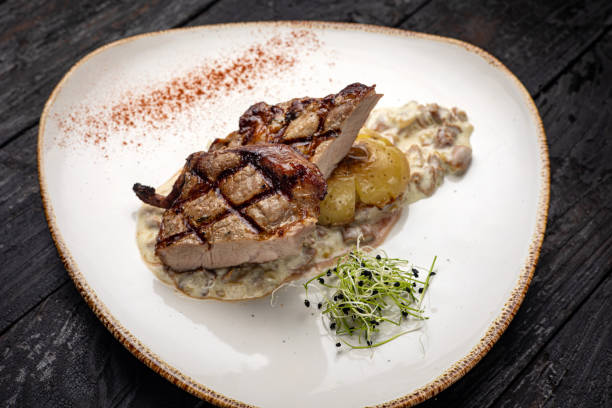 istock grilled meat with vegetables and spices on a black background 1429957370
