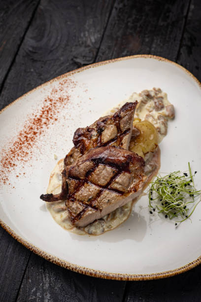 istock grilled meat with vegetables and spices on a black background 1429957587