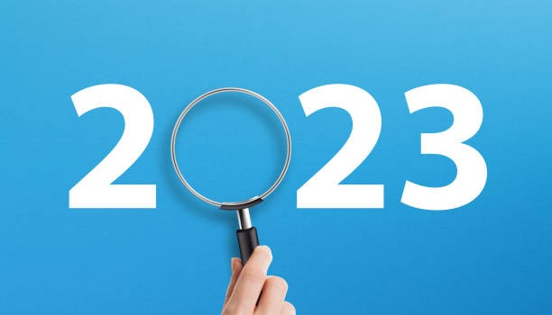 istock Happy New Year 2023 with magnifying glass on blue background 1429959090