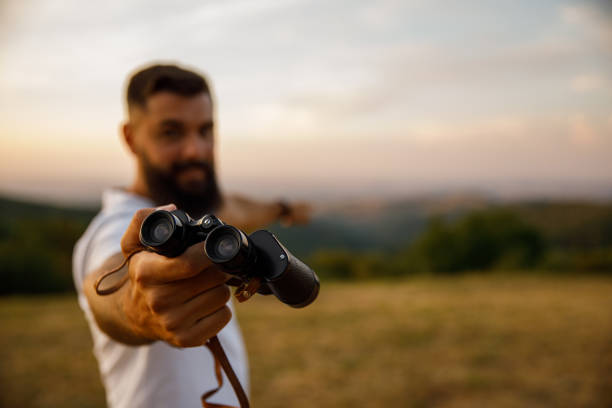 istock Giving you binoculars and pointing at where to look 1429961027