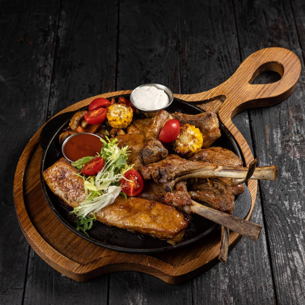 istock grilled meat with vegetables and spices on a black background 1429962057