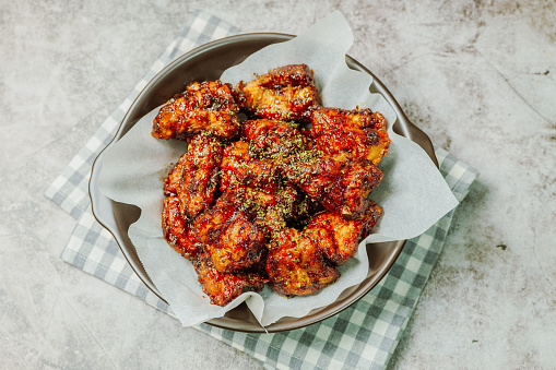 yangnyeom chicken, Korean style Seasoned Fried Chicken : This dish is seasoned chicken cut into pieces, deep- fried, and mixed with soy sauce, gochujang, or other sauces. It has a mild yet spicy taste that makes it ideal for a snack, with or without alcoholic beverages.