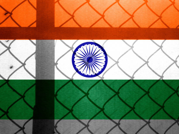 istock Backlight Backlight with actual Indian flag and barbed wire. Prison concept with border image. Double exposure hologram 1429964176
