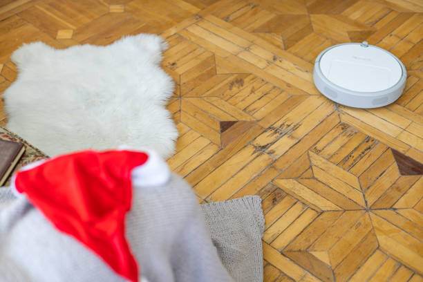 istock Robotic vacuum cleaner hoovering the floor at christmas 1429964528