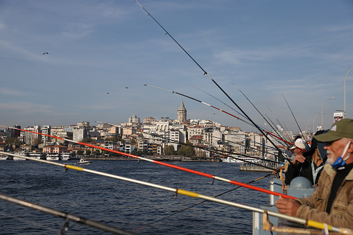 A regular day starts in Istanbul old town district with the fishermen take spots on the Istanbul Galata Bridge at dawn time
