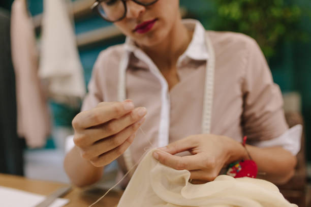 istock Woman hands doing handwork on dress 1429966094