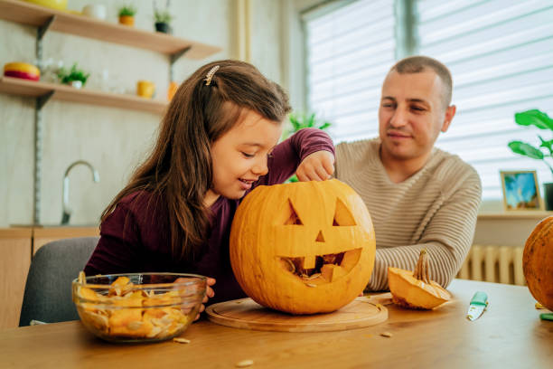 istock Father and daughter making Halloween decorations 1429966154