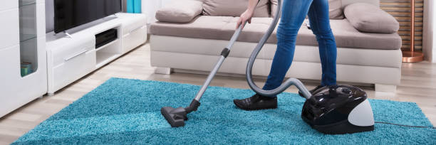 istock Man Cleaning Carpet With Vacuum Cleaner 1429968785