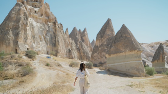 A young female traveler is walking in Cappadocia Türkiye.