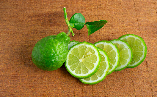 Kaffir lime, Leech lime, Mauritius papeda fruit on wooden table background