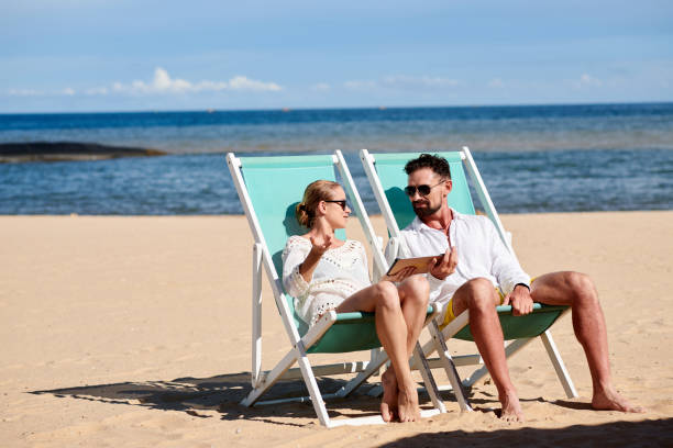 istock Couple resting together on the beach 1429974663