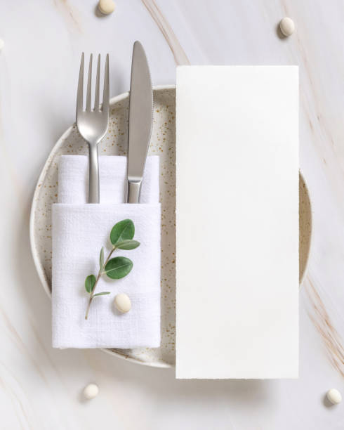 istock Elegant Table setting with a card decorated with eucalyptus branches top view, Wedding mockup 1429975721