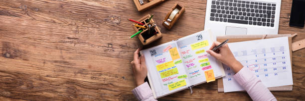 istock Businesswoman Writing Schedule In Calendar Diary 1429975761