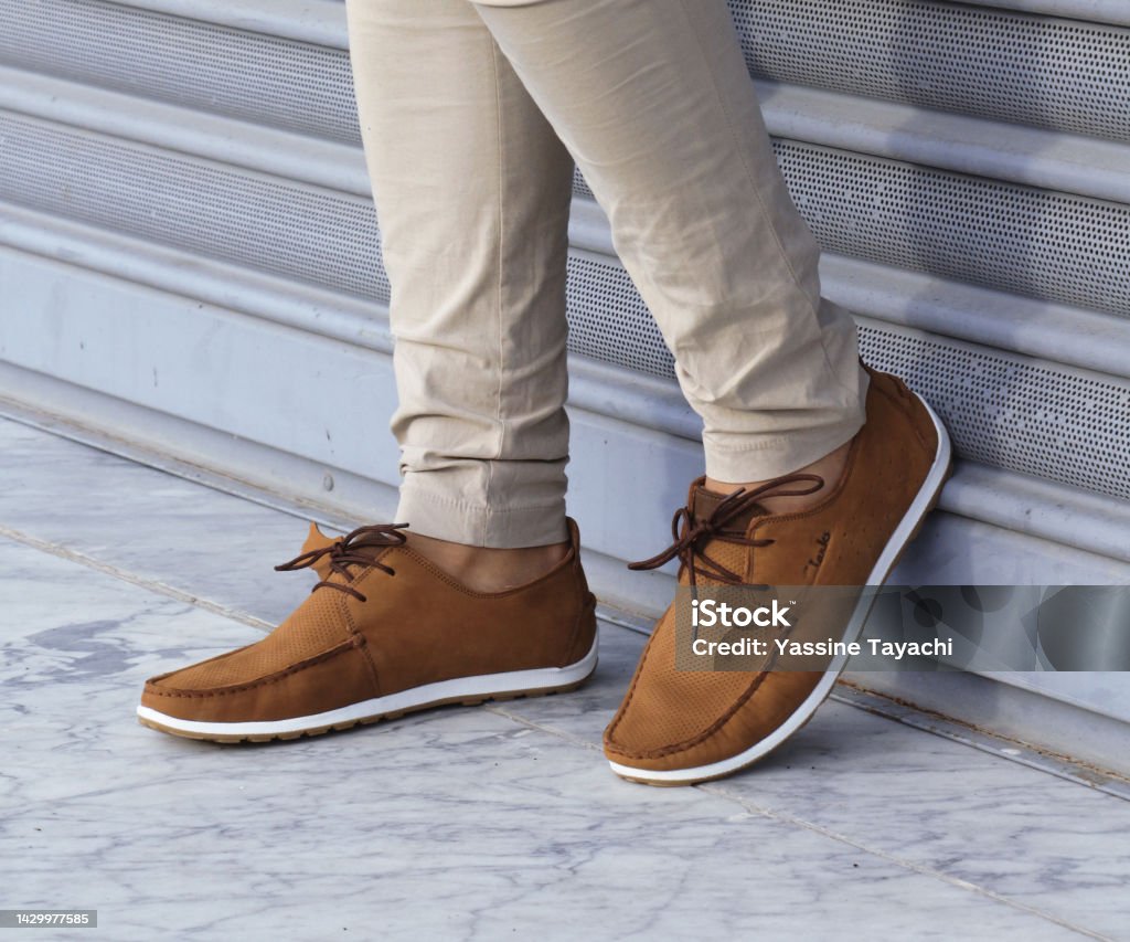 Casual man brown loafer shoes posing in the urban street. Shoe Stock Photo