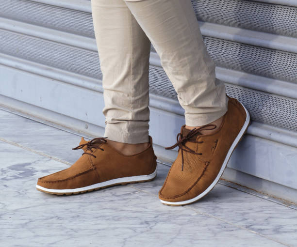 Casual man brown loafer shoes posing in the urban street. Casual man brown loafer shoes posing in the urban street. timberland arizona stock pictures, royalty-free photos & images