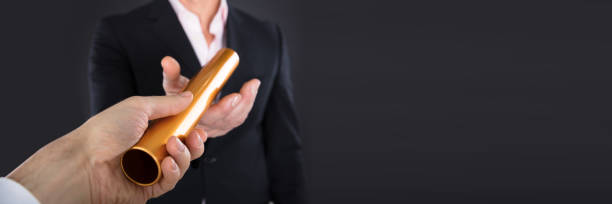 istock Businessman Passing A Golden Relay Baton 1429977850