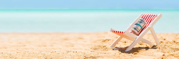 istock Rolled Up Bundle Of Fifty Dollar Banknotes On Deck Chair 1429978052