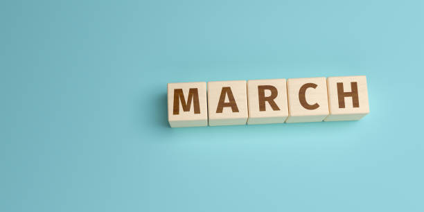 The word March built from letters on wooden cubes. High angle view with copy space stock photo