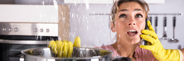 istock Woman Calling Plumber To Fix Water Leaking From Ceiling 1429979180