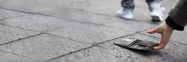 istock Person Picking Up A Lost Wallet 1429979720
