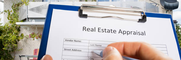istock Person Hand Filling Real Estate Appraisal Document 1429979901