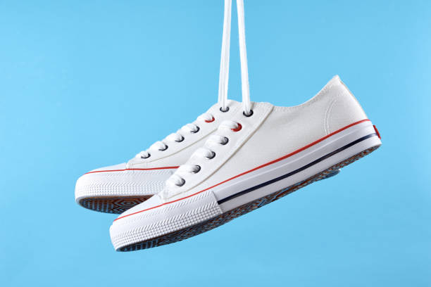 istock White casual sneakers on blue background, creative minimalism 1429980717