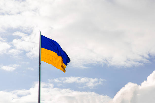 istock Ukrainian flag blowing on a wind bright sky background simple wallpaper advertising copy space concept 1429982497