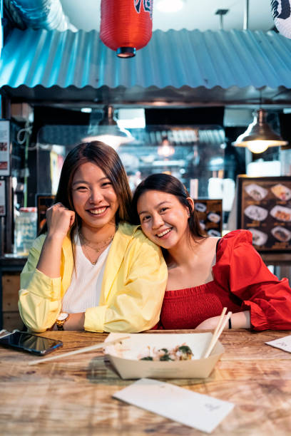 istock Pretty Friends in Asian Restaurant 1429984336
