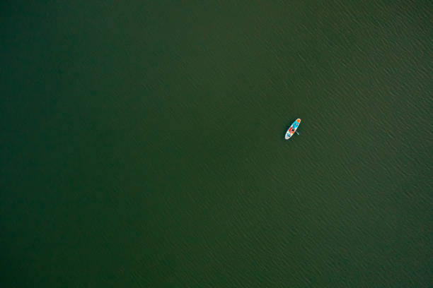 istock Drone point view of young man, lying on a standup paddleboard 1429985467